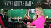 Evelyn cuts ribbon for Star Guitar Bar